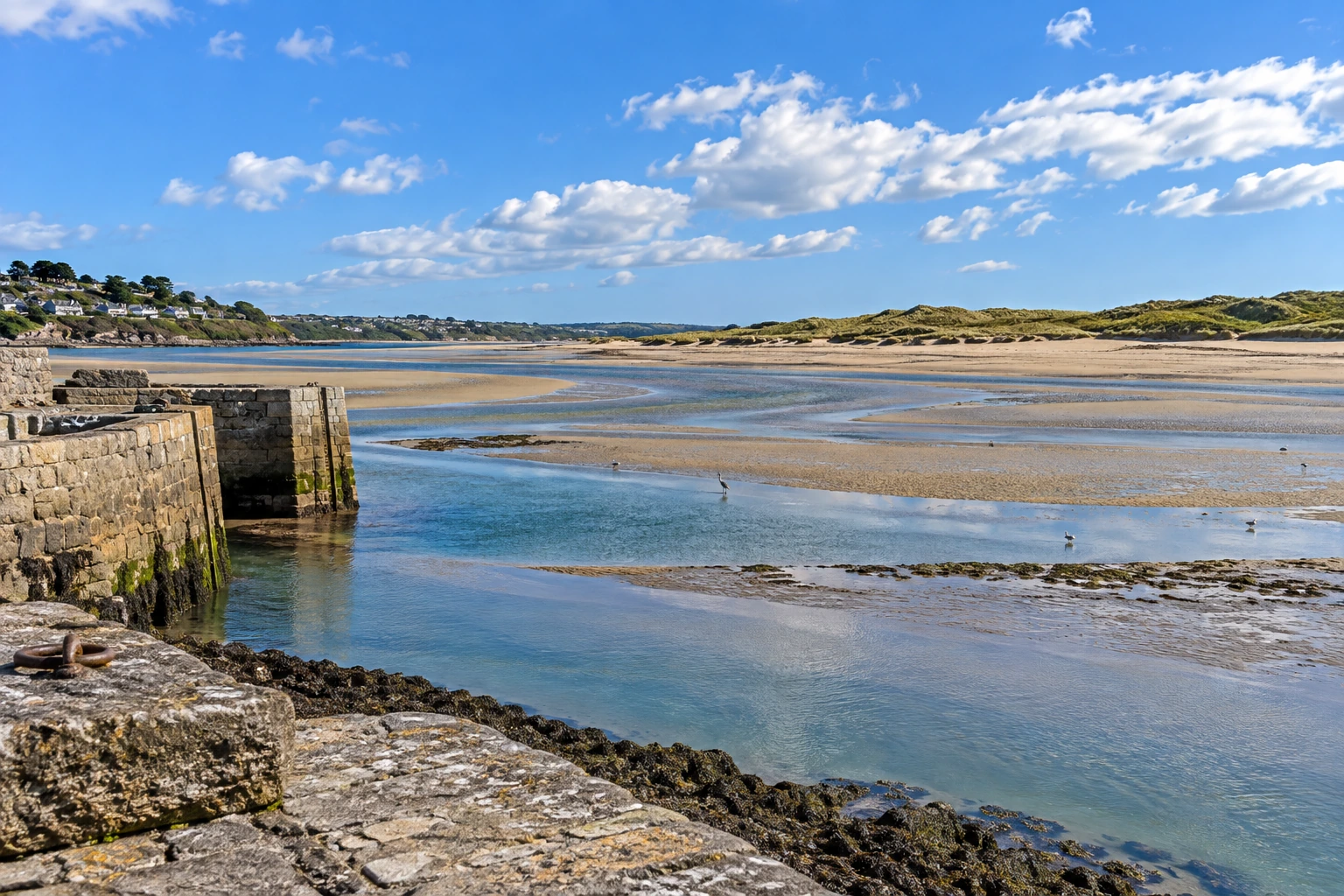Excavator cutting foundations on a development plot near the Hayle estuary