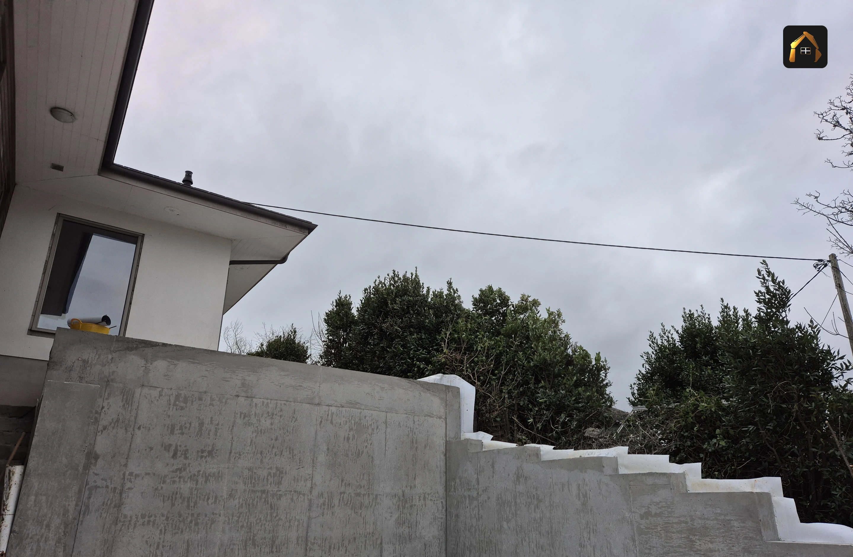Completed stepped retaining wall and concrete slab in Helford