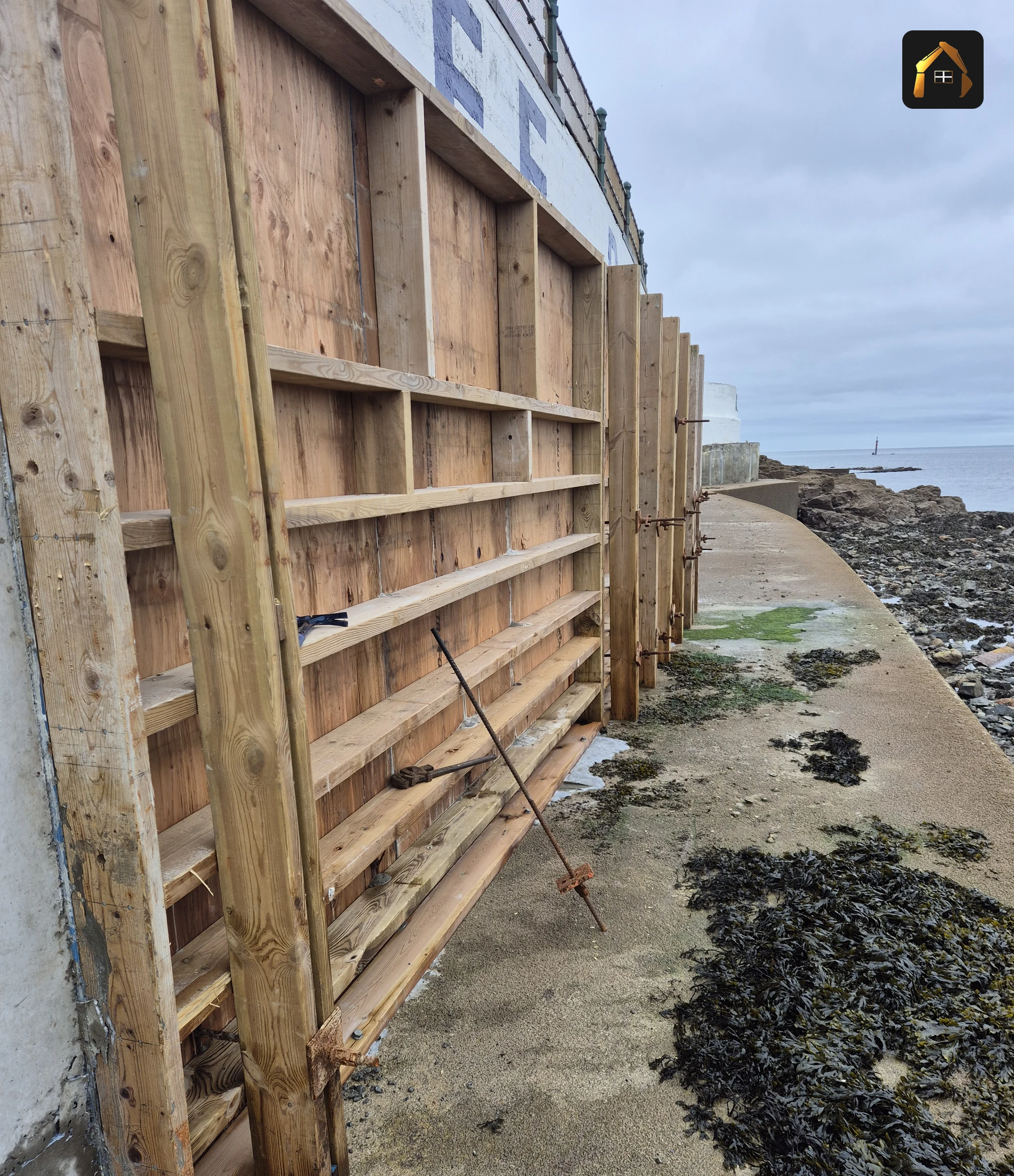 Timber shuttering against the Jubilee Pool sea wall at low tide in Penzance