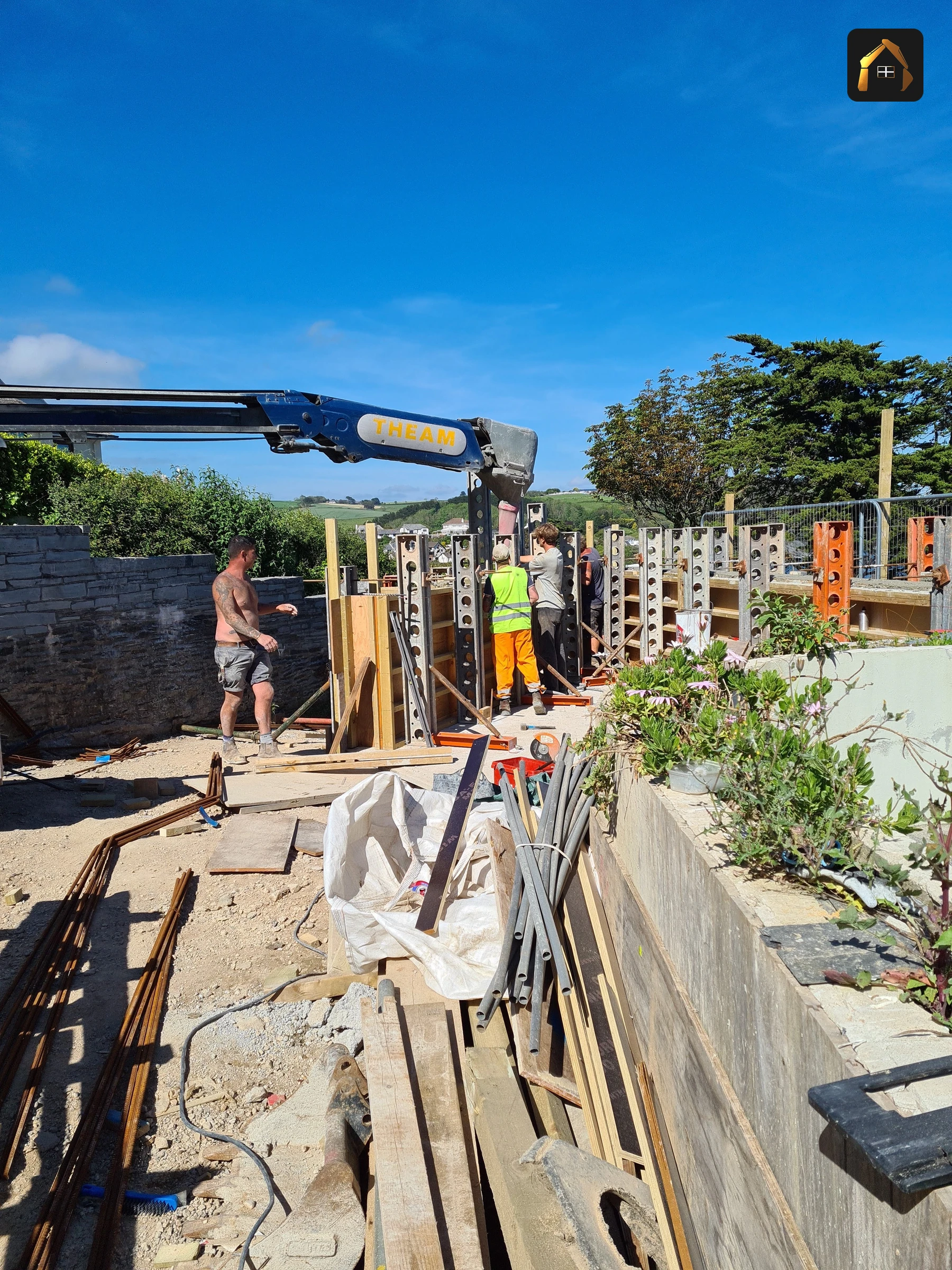 Concrete conveyor feeding the terrace of a clifftop house in Looe