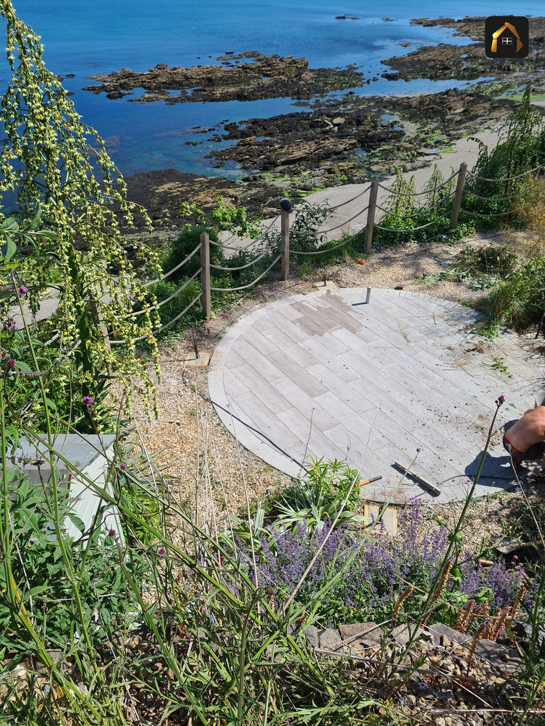 Completed stone circle terrace set into coastal planting in Looe