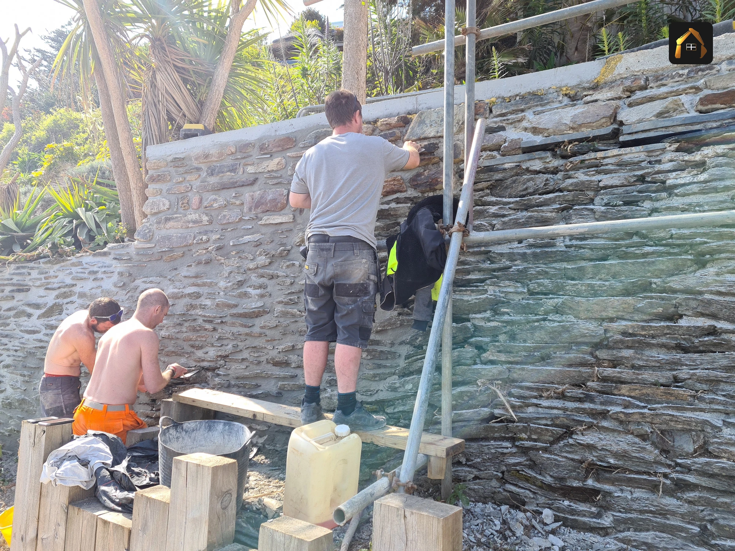 Two workers cutting stone on the terrace in Looe