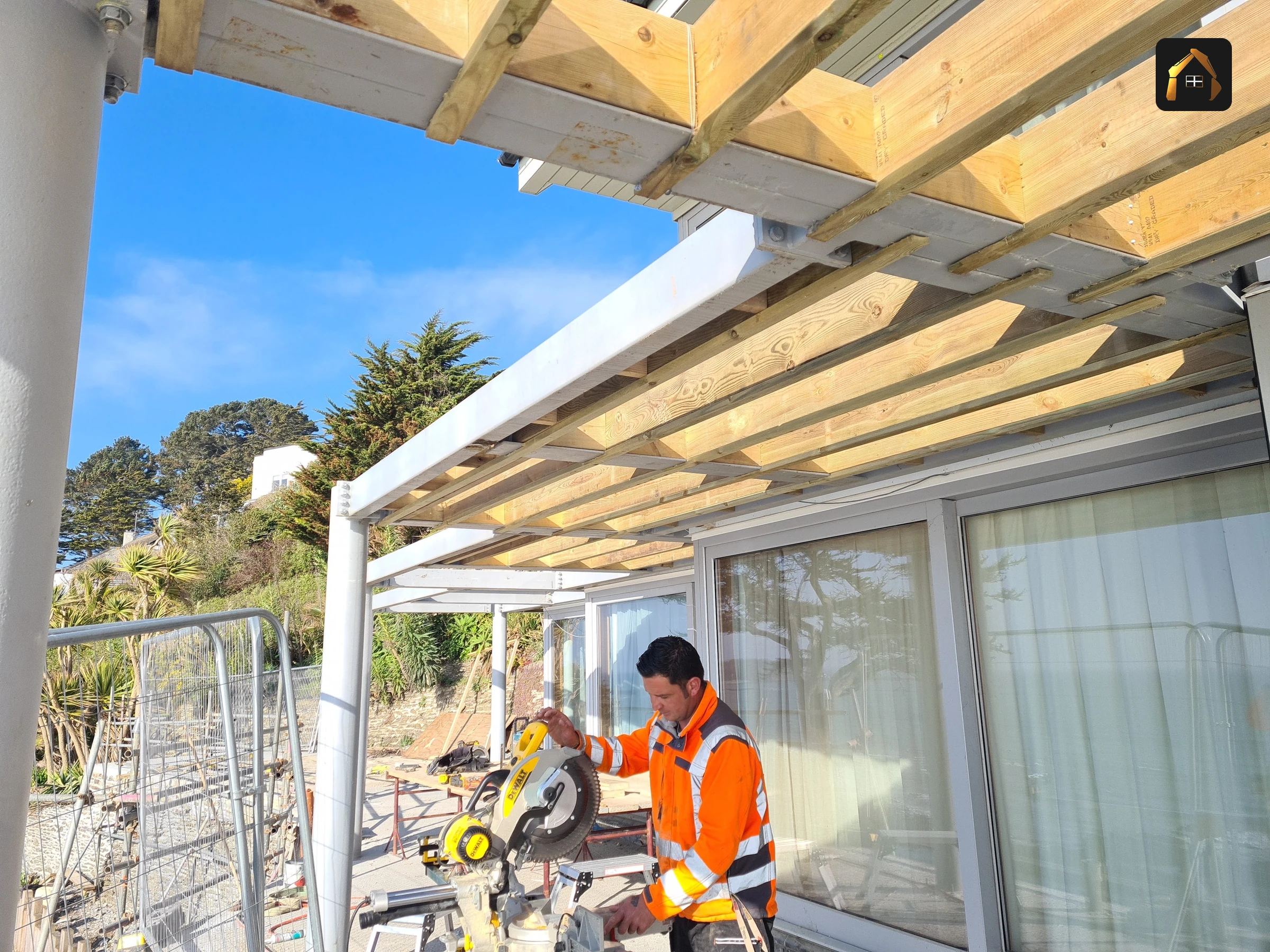 Workers installing a timber canopy structure in Looe