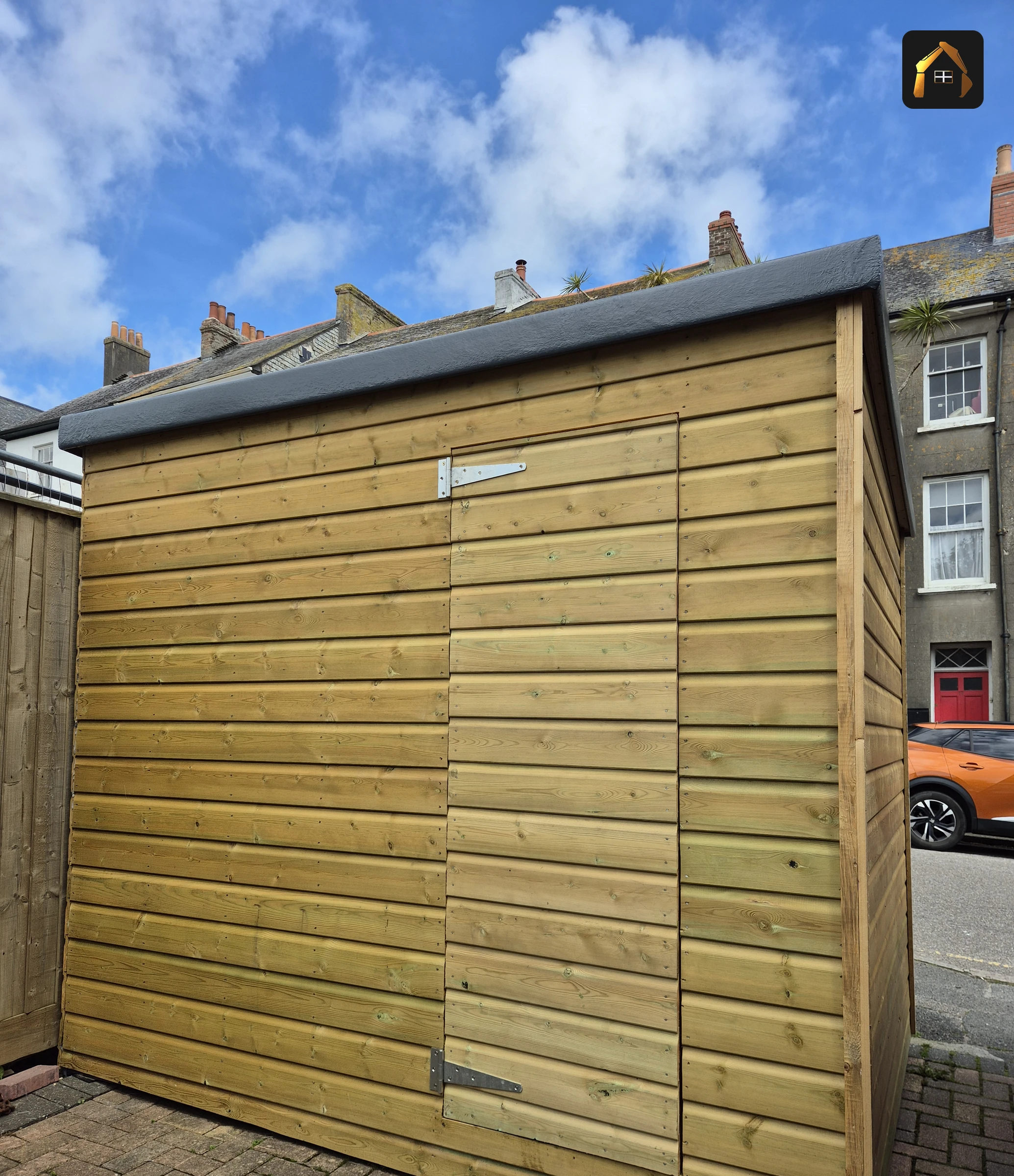 Completed shiplap clad timber garden building on block paving in Penzance