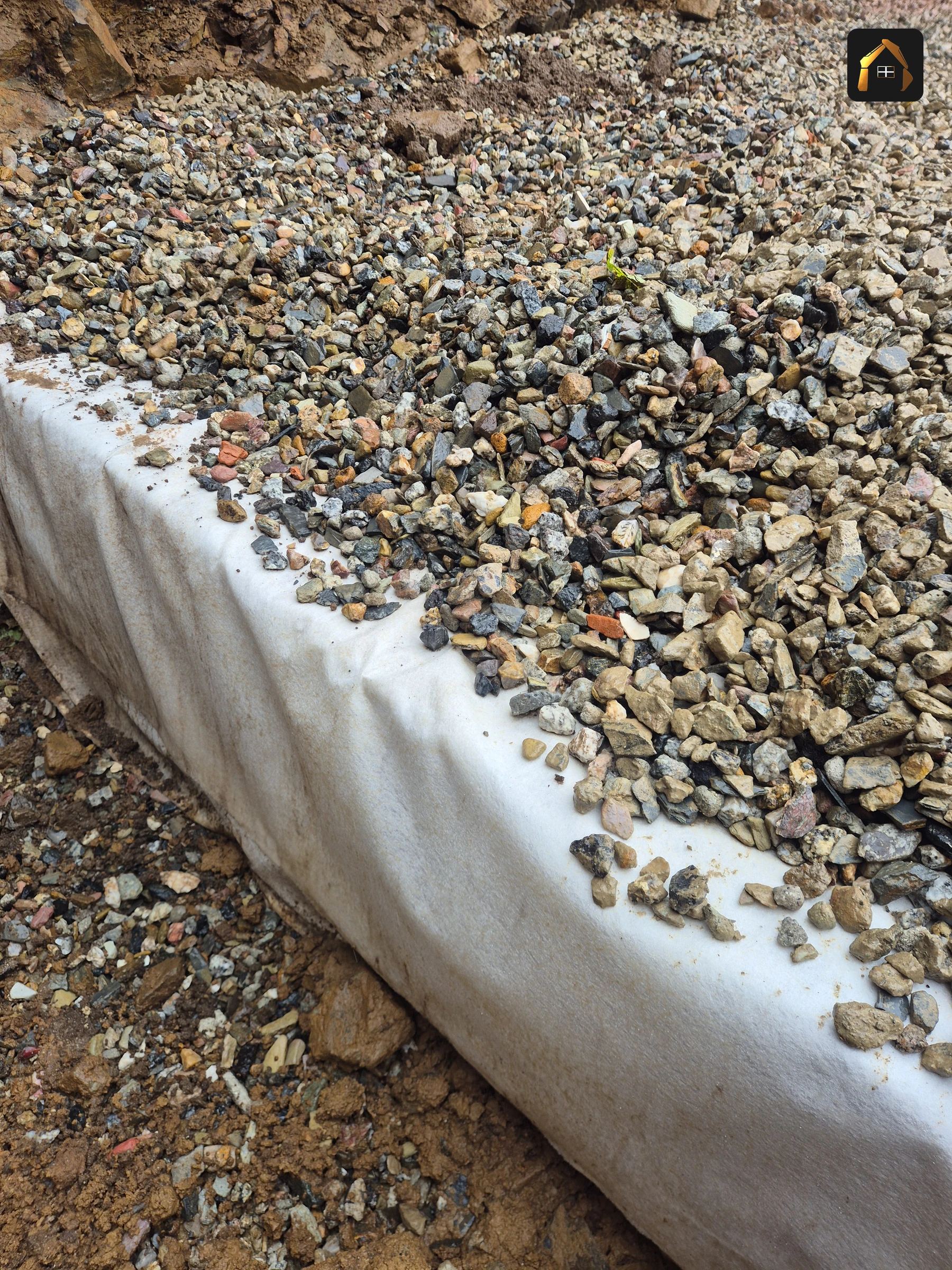 Clean stone backfilled against membrane wrapped soakaway crates at Carrick Lodge, St Ives