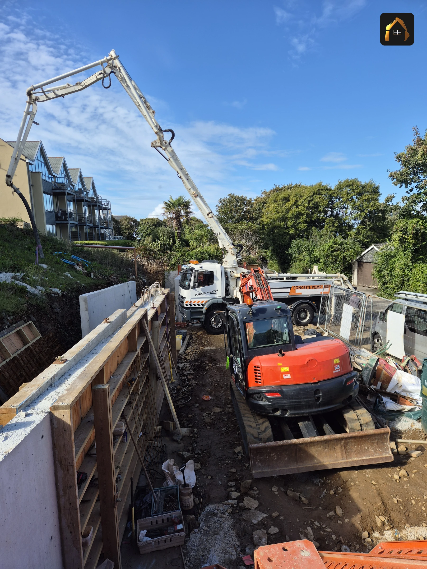 Concrete pump discharging into the retaining wall shuttering at Carrick Lodge in St Ives