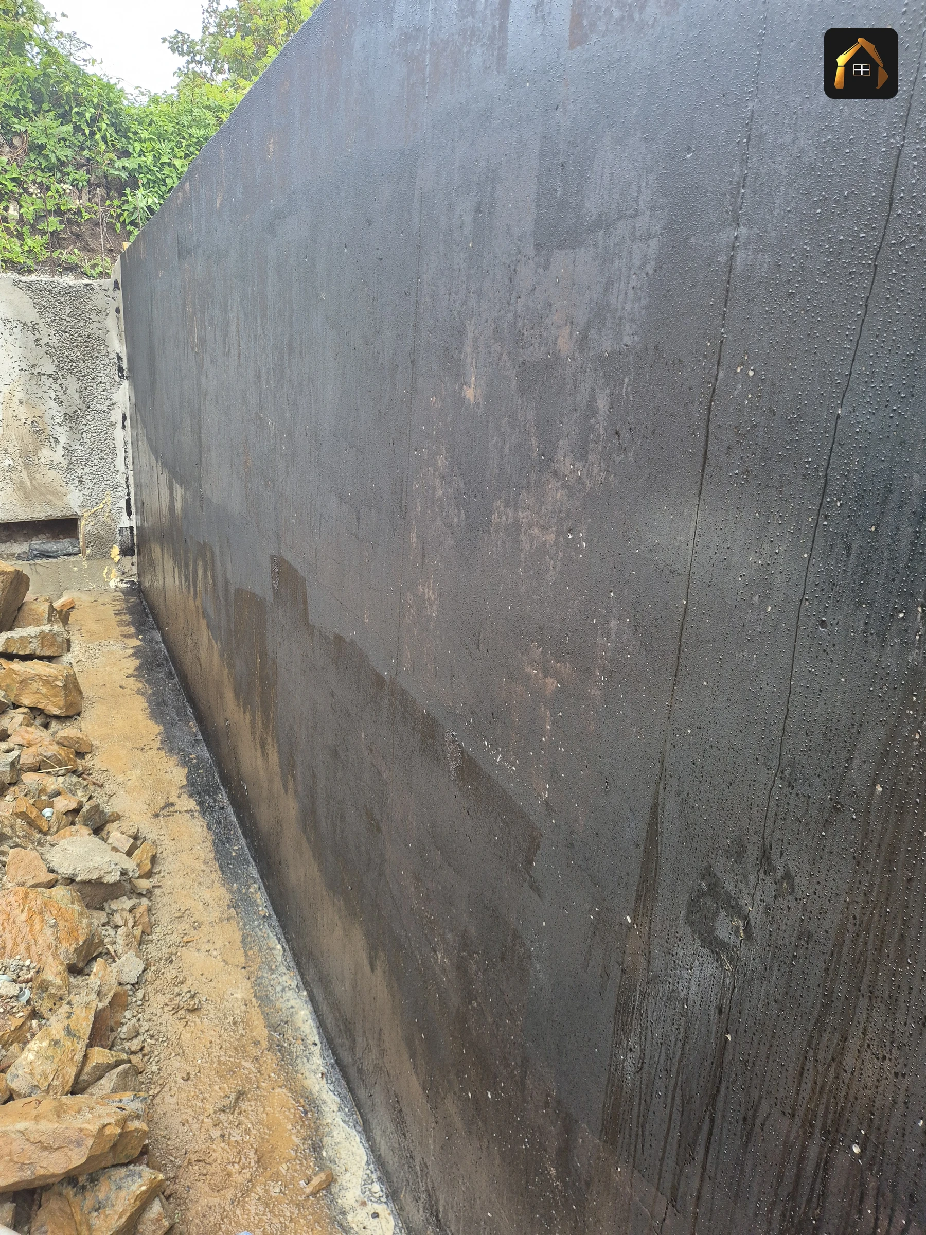 Completed tall concrete retaining wall with a board marked face at Carrick Lodge in St Ives