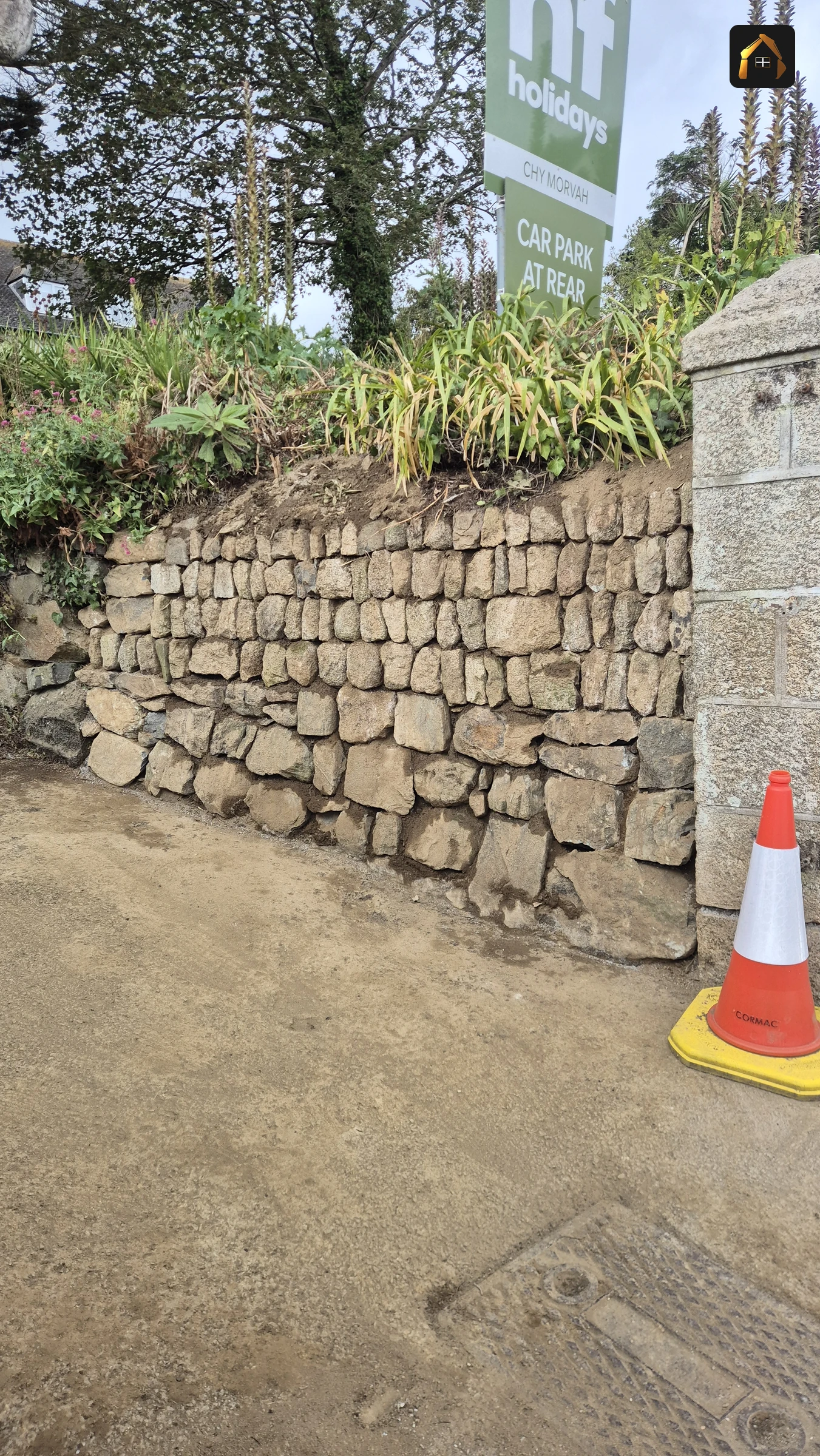 Completed dry stone Cornish hedge with a dressed granite pier in St Ives